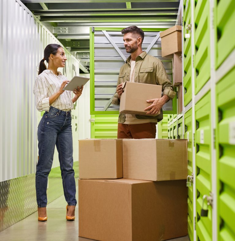 Two people filling their self storage unit with stock